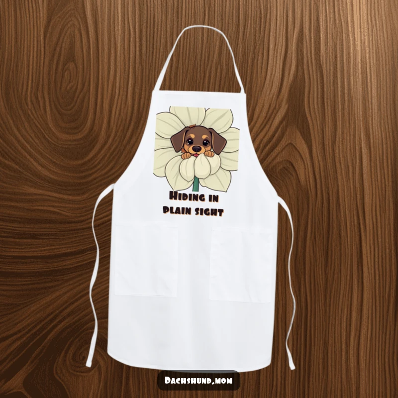 Funny apron showing a kawaii dachshund curiously peeking from behind a giant flower, making kitchen duty fun and cute.