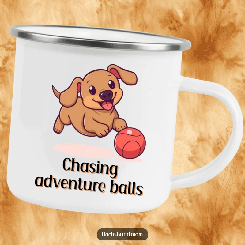Funny enamel camping mug showing a dachshund playfully chasing a bouncing ball, ideal for active outdoor adventures.