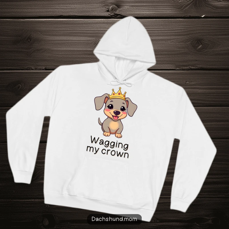 Funny kawaii dachshund wearing a crown and wagging its tail, designed for a warm and humorous hoodie.