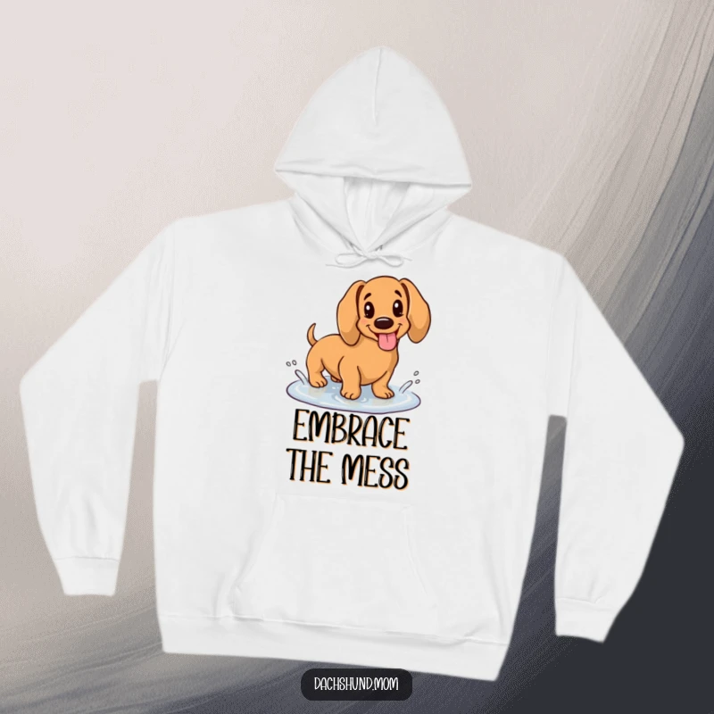 Funny hoodie featuring a kawaii dachshund with its tongue sticking out, happily splashing in a puddle, radiating youthful exuberance.