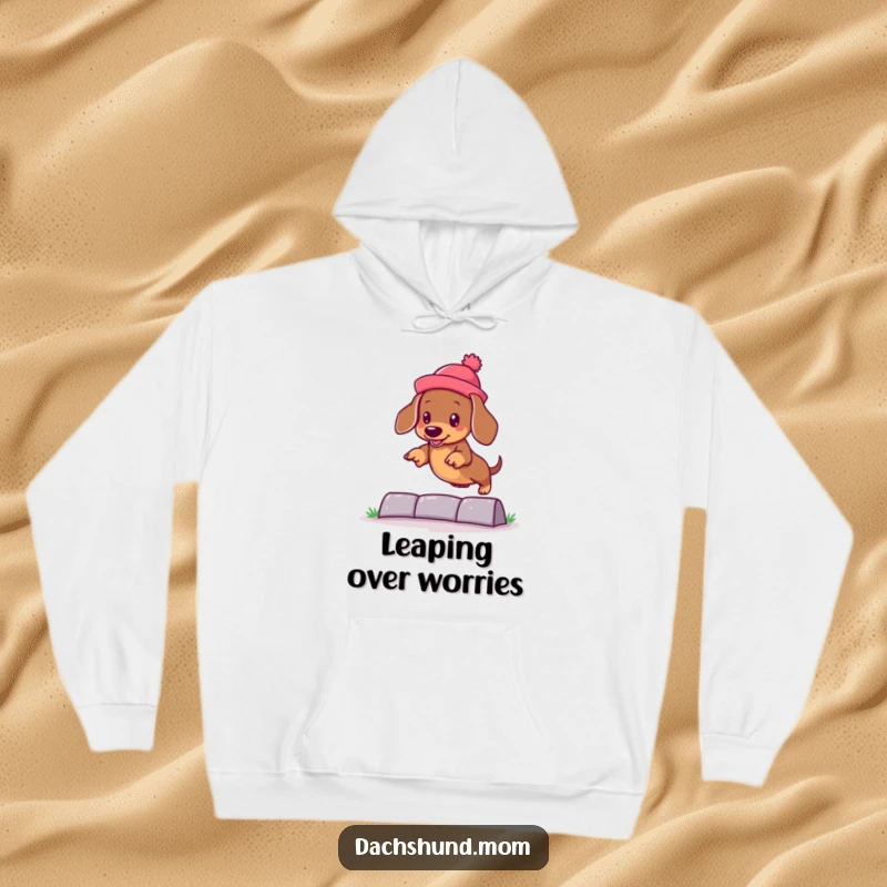 Funny kawaii dachshund wearing a silly hat, jumping over an obstacle on a cozy hoodie, perfect for dog lovers.