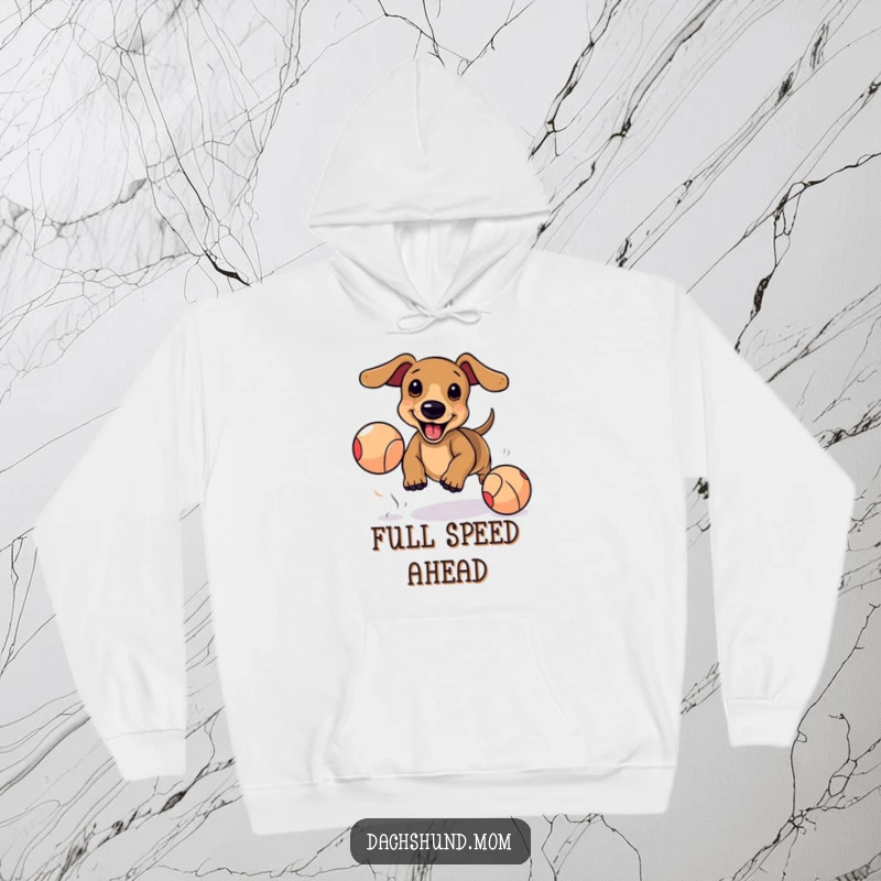 Funny Kawaii Dachshund Hoodie: Adorable dog excitedly chasing bouncing ball, cozy cute apparel, energetic pet owner.