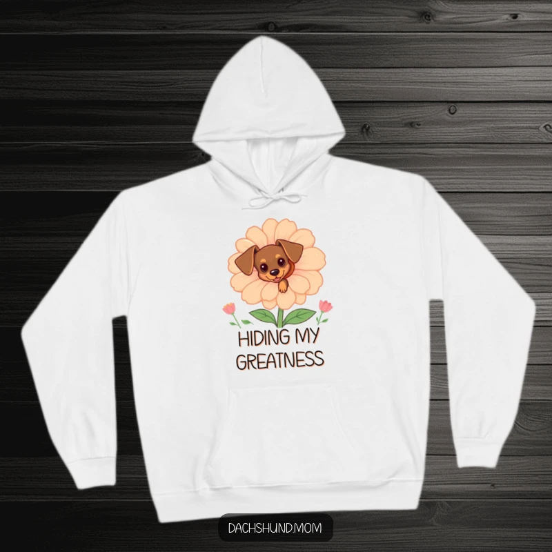 Funny tiny dachshund peeking from behind a large flower on a cozy hoodie, perfect for dog lovers seeking charm.