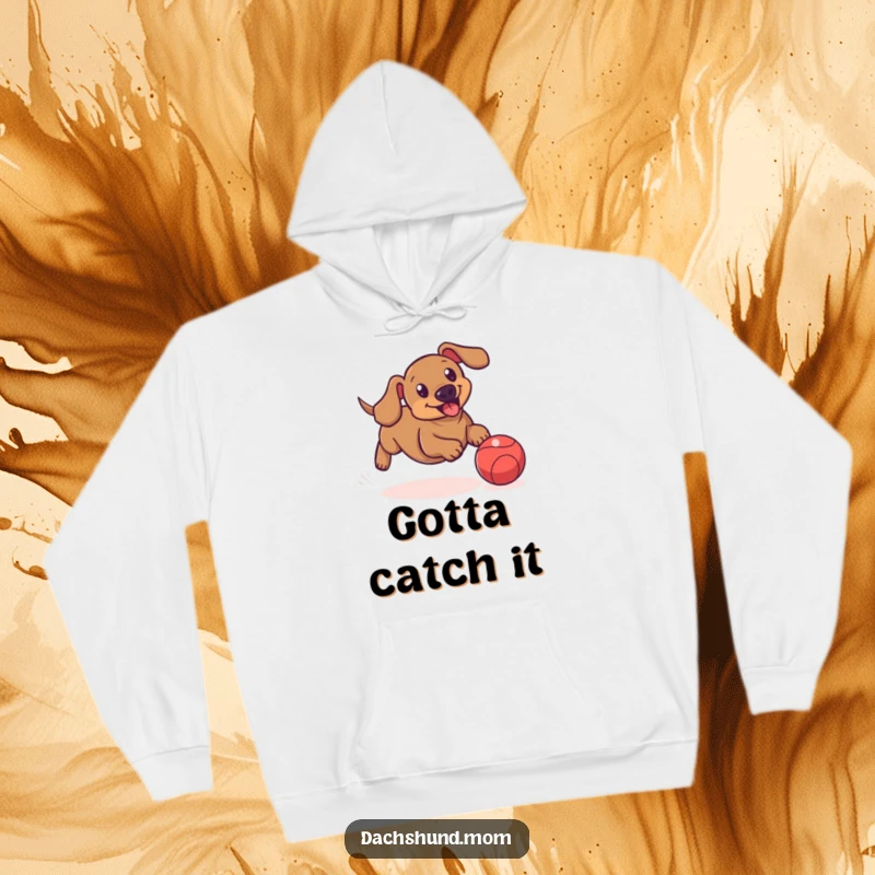 Funny hoodie depicting a dachshund playfully chasing a bouncing ball, exuding athleticism and fun.