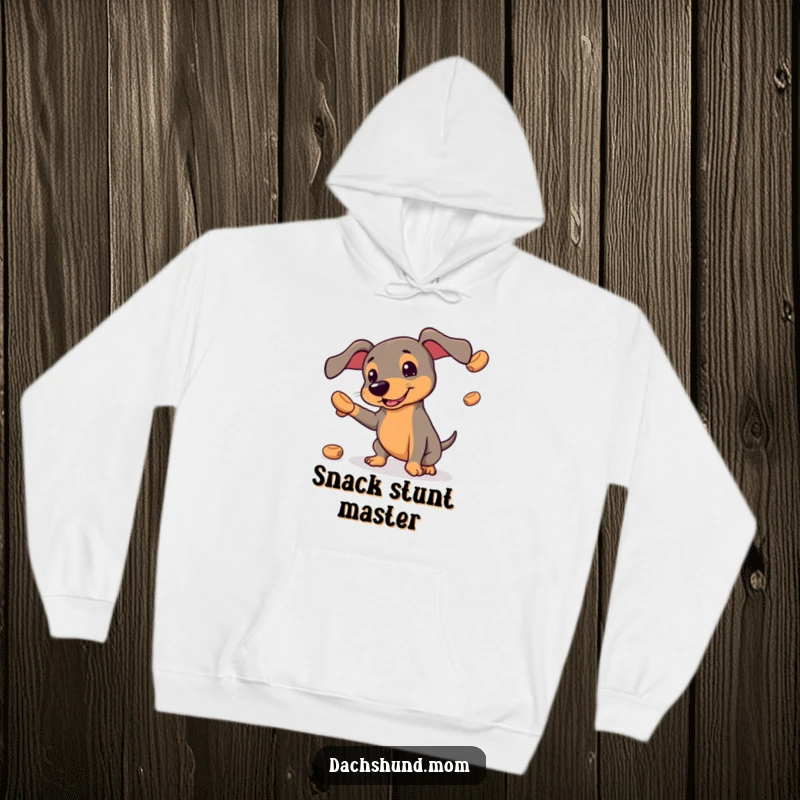 Funny kawaii dachshund hoodie, a determined dog hilariously juggling treats, blending coziness with comical action.