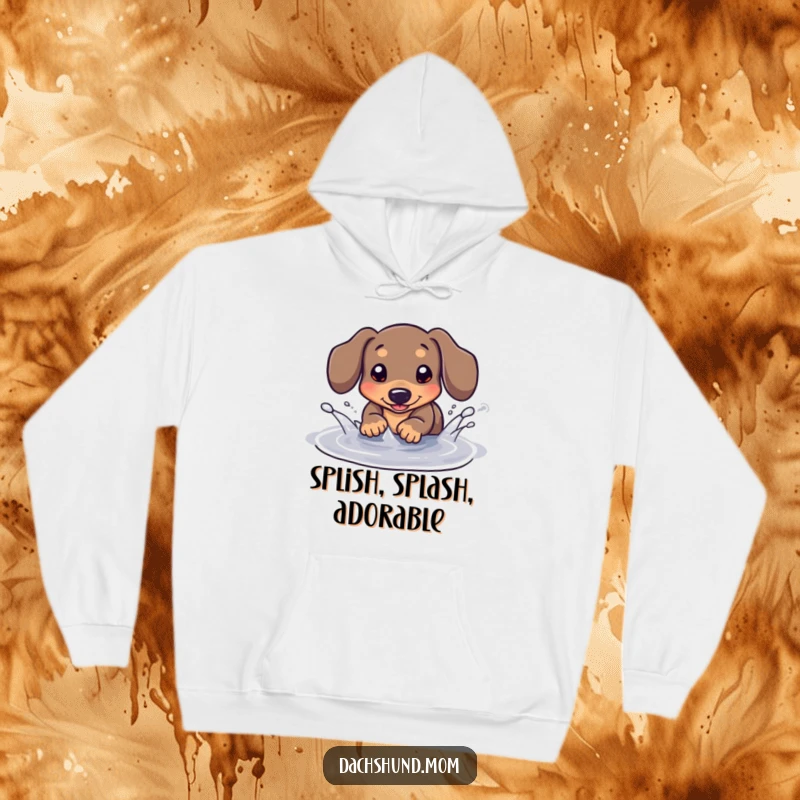 Funny Kawaii Dachshund Hoodie: A cute dachshund joyfully splashes in a tiny puddle, designed for cozy, fun-filled days.