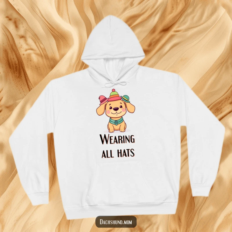 Funny Kawaii Dachshund Hoodie depicting a charming dog expertly balancing a precarious stack of different tiny hats.