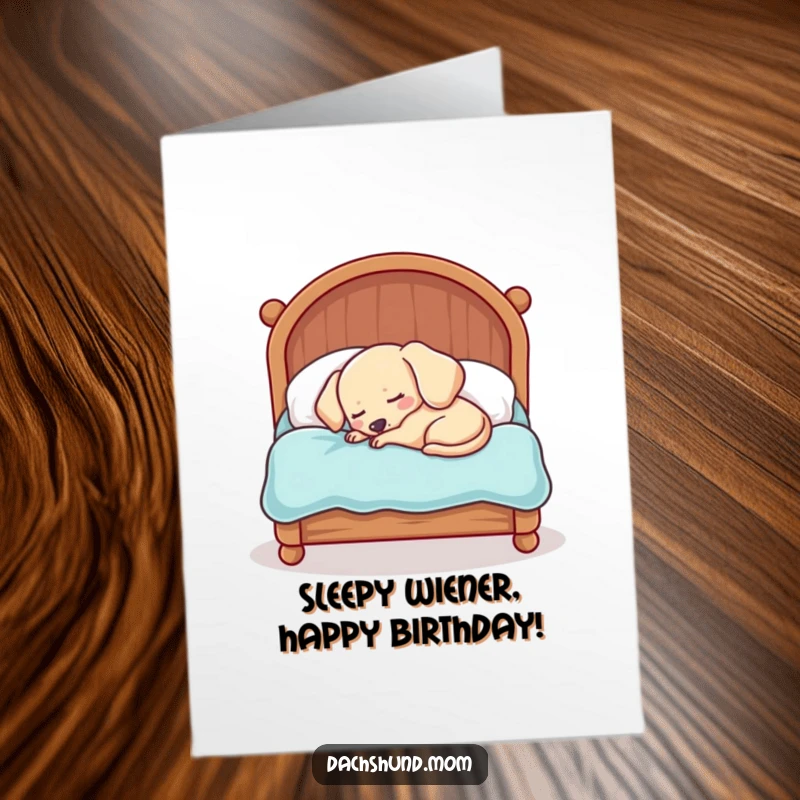 Funny Free Printable Birthday Card: Sleepy kawaii dachshund curled in a comically small bed, humorous nap gift.