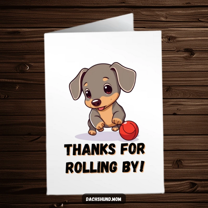Funny free printable thank you card: A cute dachshund cub intently rolling a small red ball, showing thanks.