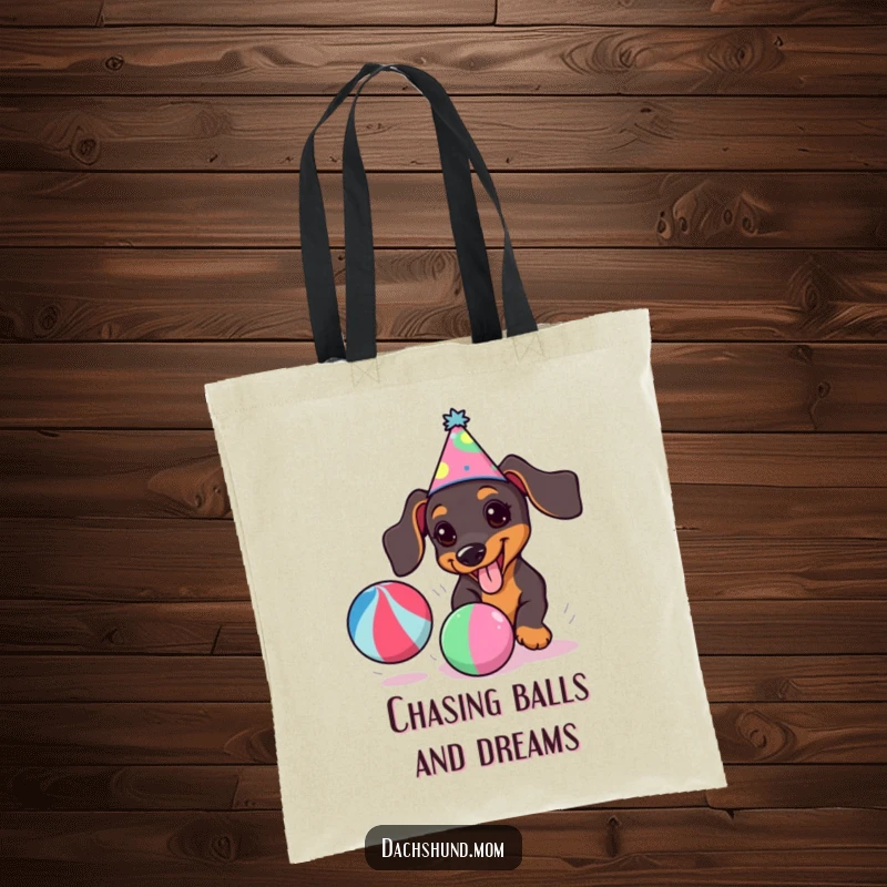 Funny kawaii dachshund with a party hat, enthusiastically chasing a bright ball, adorns this practical tote bag.